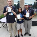 Three people accepting awards at special olympics ice cream social