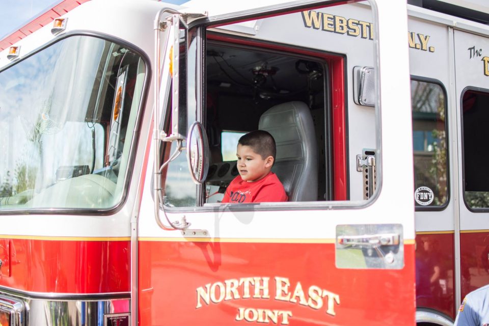 Little boy in a fire truck at the autism awareness fair