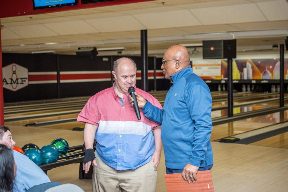 Two people giving a speech at bowling event