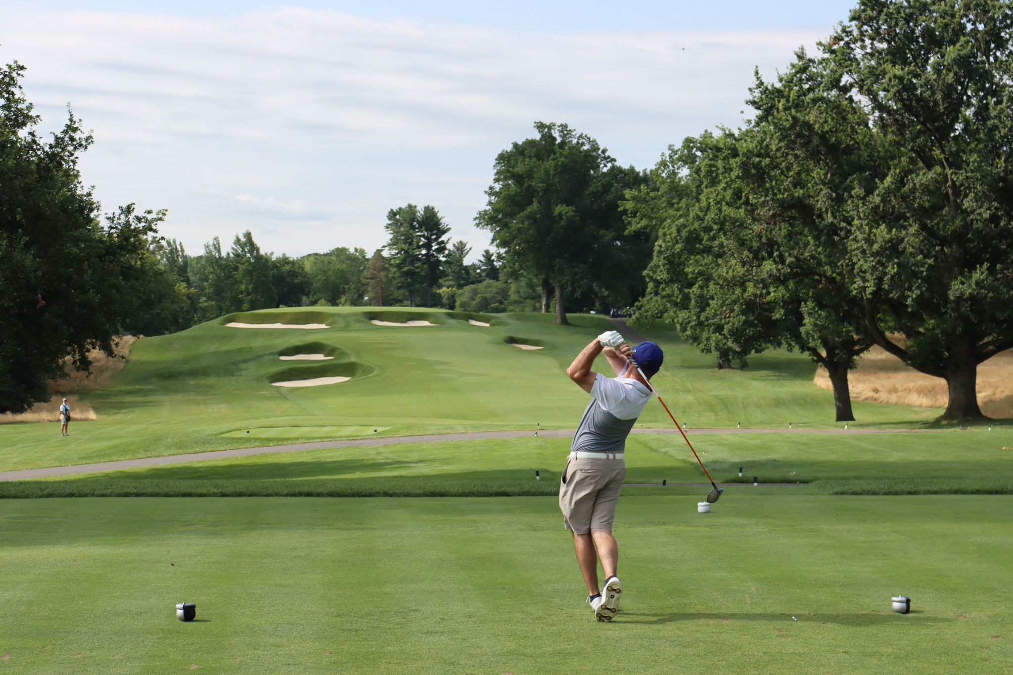 A golfer hits a tee shot at the 38th A Salute to Veterans Golf Tournament at Oak Hill Country Club.